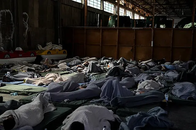 Survivors of the shipwreck at a warehouse 