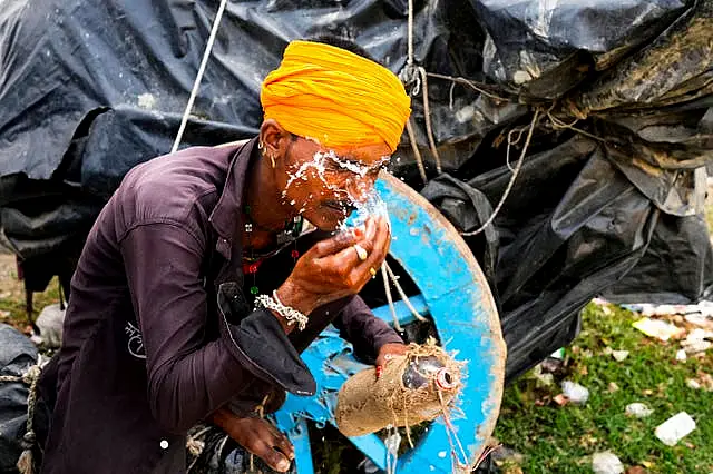 A man splashes water on his face to cool himself in Lalitpur district in northern Uttar Pradesh state 