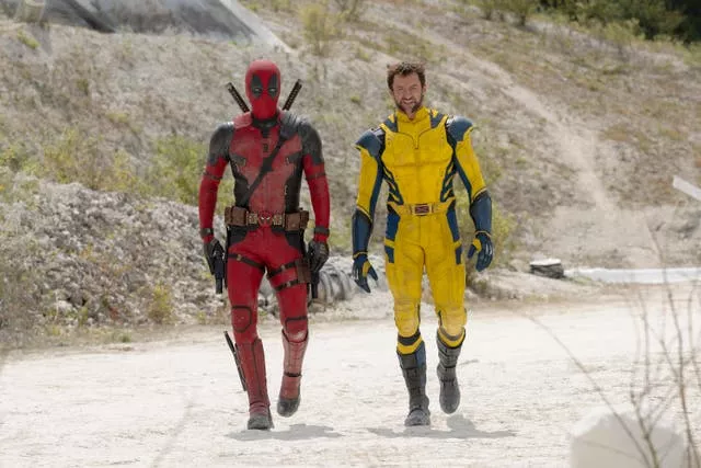 Deadpool and Wolverine walking along a path