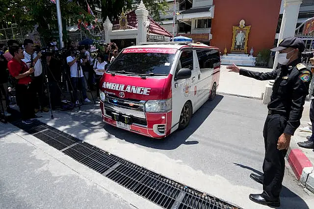 An ambulance carrying an injured student leaves the school in Bangkok 