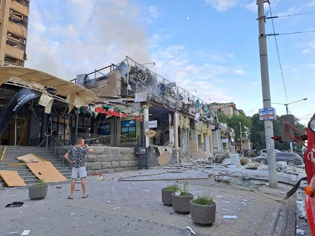 A man stands on the street in front of the restaurant destroyed by a missile attack in Kramatorsk