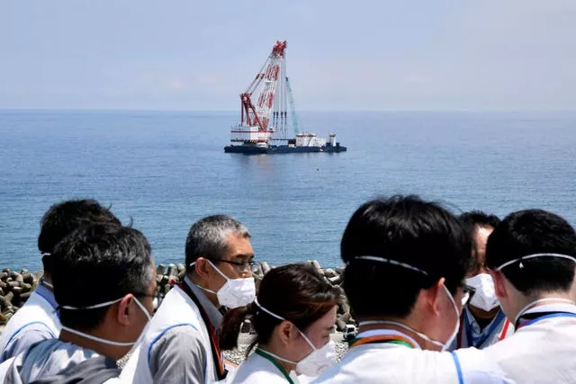 A work ship is seen offshore where Tokyo Electric Power Company Holdings said it installed the last piece of an undersea tunnel dug to be used to release the water offshore
