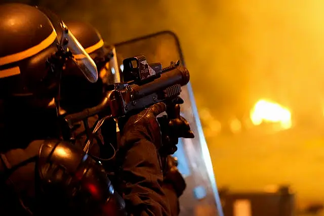 A police officer fires teargas during clash with youths in Nanterre 