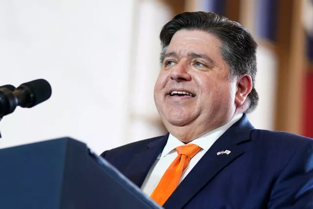  JB Pritzker speaking into a microphone