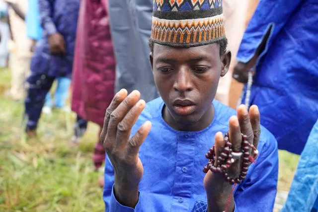 A Nigerian muslim attends Eid prayers at an open field in Lagos, Nigeria, on Wednesday