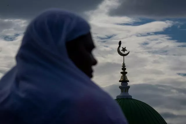 A Muslim attends prayers during Eid-al-Adha at a mosque in Kathmandu, Nepal
