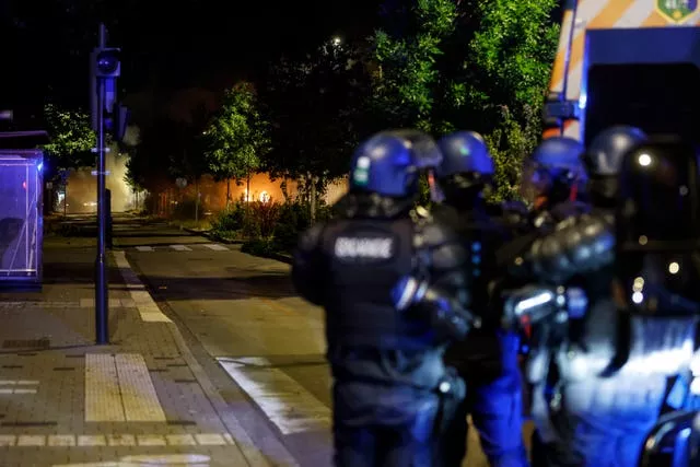 Riot police stand guard in the La Meinau neighbourhood of Strasbourg, eastern France