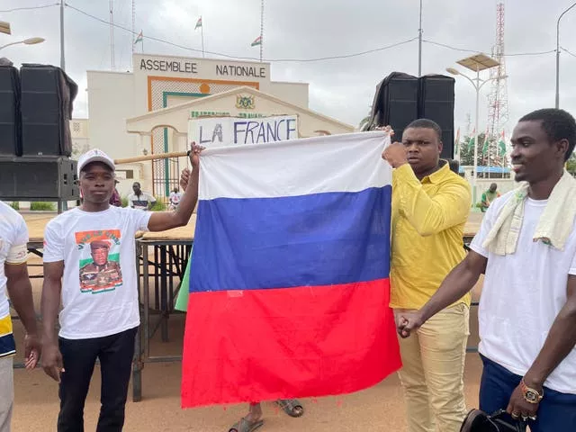 Supporters of Niger’s ruling junta hold a Russian flag at the start of a protest called to fight for the country’s freedom and push back against foreign interference in Niamey, Niger