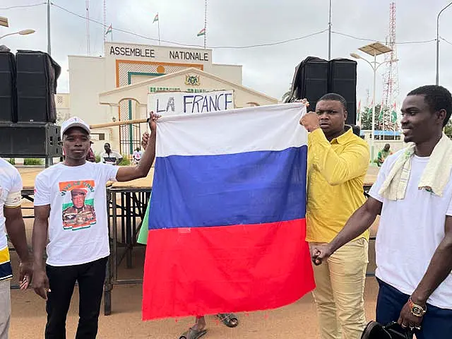 Supporters or Niger’s ruling junta hold a Russian flag at the start of a protest called to fight for the country’s freedom and push back against foreign interference in Niamey, Niger, on Thursday 