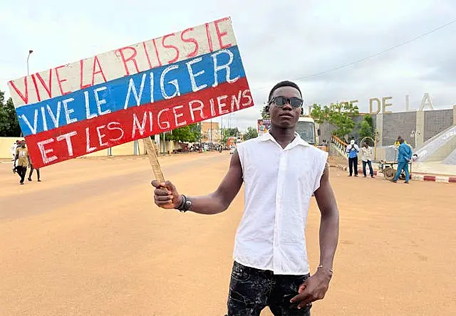 A supporter of Niger’s ruling junta holds a placard in the colors of the Russian flag reading 'Long Live Russia, Long Live Niger and Nigeriens' at the start of a protest called to fight for the country’s freedom and push back against foreign interference in Niamey, Niger, on Thursday 