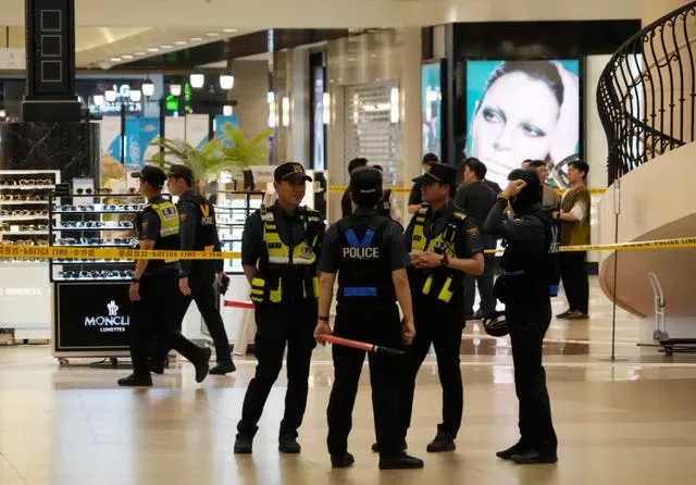Police officers cordon off the scene near a subway station in Seongnam, South Korea
