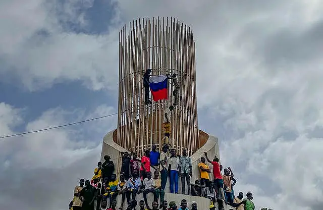 Supporters of Niger’s ruling junta hold a Russian flag at the start of a protest called to fight for the country’s freedom and push back against foreign interference in Niamey, Niger