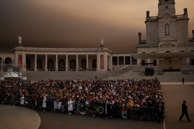 Worshippers await the arrival of Pope Francis at Our Lady of Fatima shrine in Fatima, central Portugal