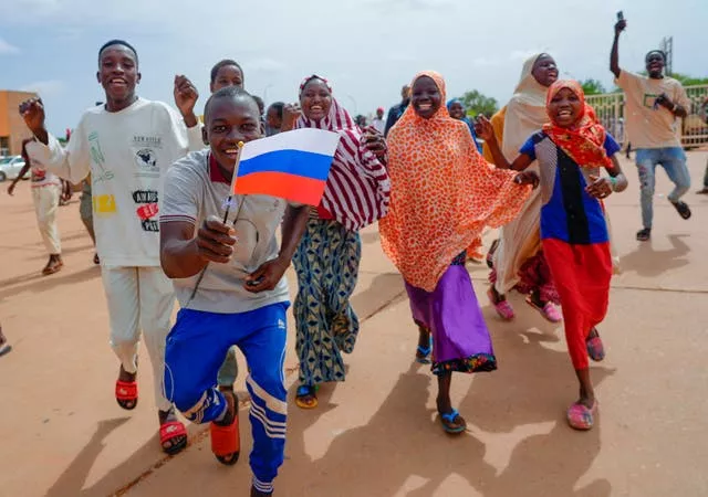 Supporters of Niger’s ruling junta hold a Russian flag