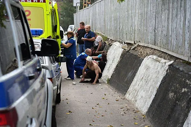 Emergency medics treat injured people at the factory