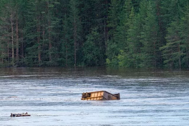 Cottage floats along flooded river