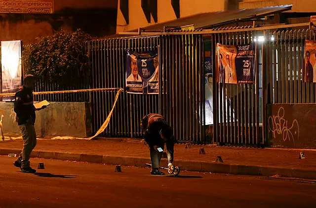 Police investigators at the scene outside the school where the shooting took place