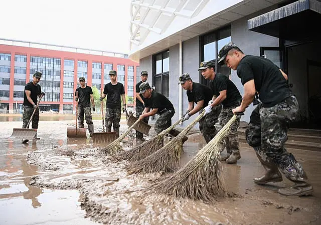 Police officers clean up sludge