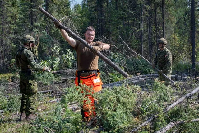 Canadian Armed Forces soldiers construct a firebreak in Parker Recreation Field in Yellowknife to help fight wildfires