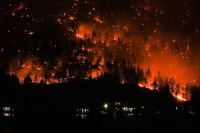 A wildfire burns on the mountainside