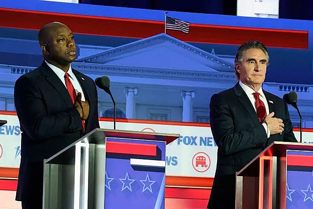 Republican presidential candidates Senator Tim Scott and North Dakota governor Doug Burgum stand on stage before a Republican presidential primary debate in Milwaukee 