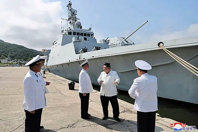 Kim Jong Un before a navy ship