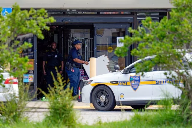 Law enforcement officials remove items from a Dollar General store at the scene of a mass shooting, in Jacksonville, Florida