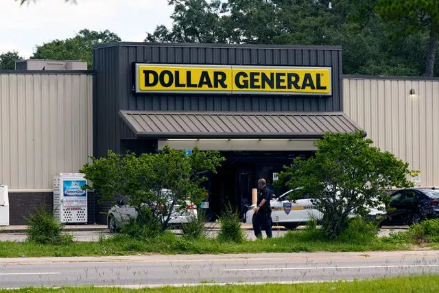 Law enforcement officials continue their investigation at a Dollar General store that was the scene of a mass shooting in Jacksonville, Florida
