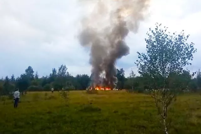 Smoke and flames rise from the crashed private jet near the village of Kuzhenkino