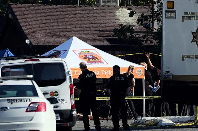 Police at the scene of the mass shooting at Cook’s Corner in California