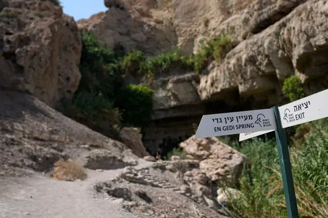 Signs direct visitors to a spring near the site of a rockslide that took place in the Ein Gedi Nature Reserve, on the western shore of the Dead Sea, a popular tourist site in Israel
