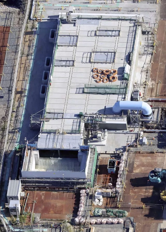 This aerial view shows the treated water, bottom, diluted by seawater flowing into a secondary water then into a connected undersea tunnel for an offshore discharge at the Fukushima Daiichi nuclear power plant in Fukushima, northern Japan