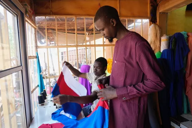 Seamsters make Russian flags in Niamey, Niger