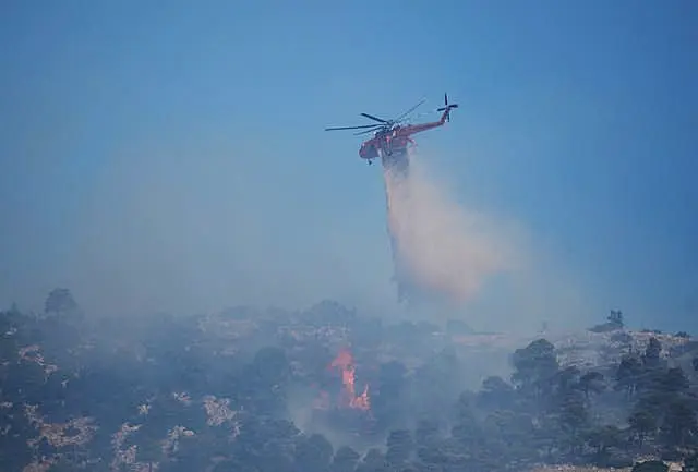 Firefighting helicopter drops water