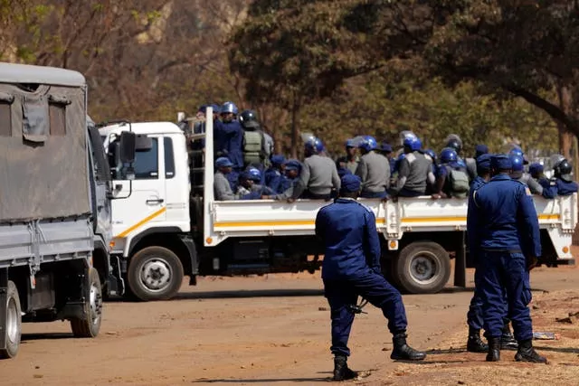 Armed riot police prepare to be deployed on the streets of Harare
