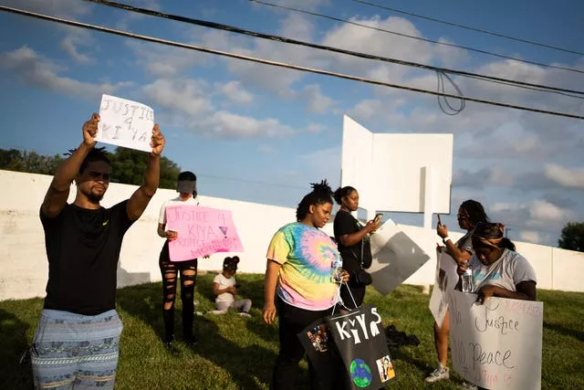 Friends, family and activists gather on Friday to protest against the shooting of Ms Young 