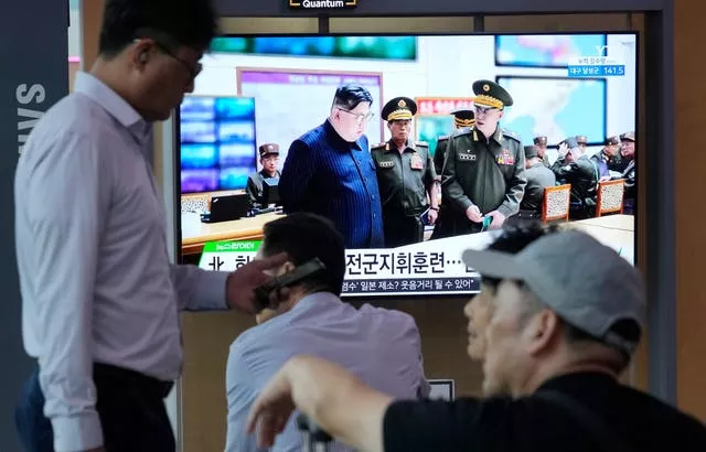 A TV screen shows an image of North Korean leader Kim Jong Un 