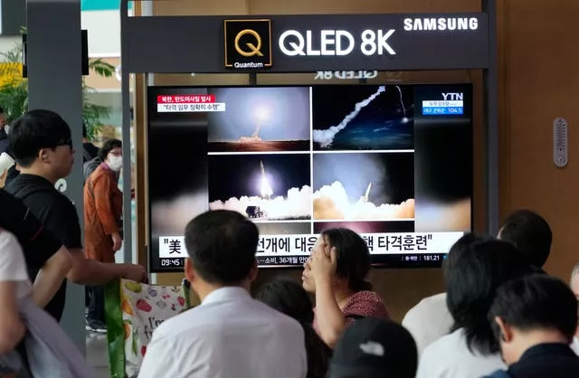 TV screen in train station showing missile launch images
