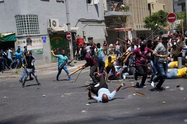 Anti-Eritrean government activists, left, clash with supporters of the Eritrean government