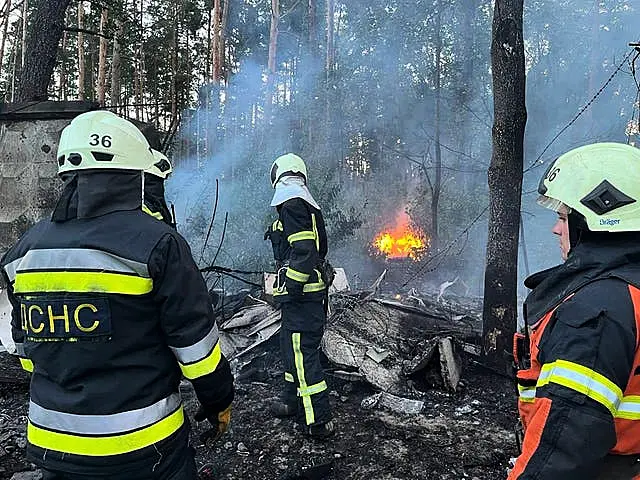 Rescuers work to extinguish a fire