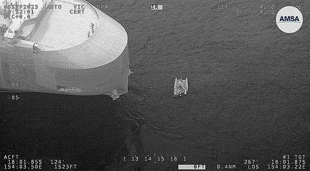 A boat near the partially submerged catamaran