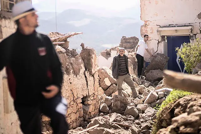 People inspect their homes damaged in the earthquake 