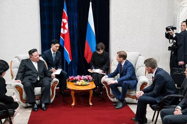 O líder da Coreia do Norte, Kim Jong Un, à esquerda, é recebido pelo ministro russo de recursos naturais e ecologia, Alexander Kozlov, sentado à direita, depois de cruzar a fronteira com a Rússia em Khasan, cerca de 127 km (79 milhas) ao sul de Vladivostok