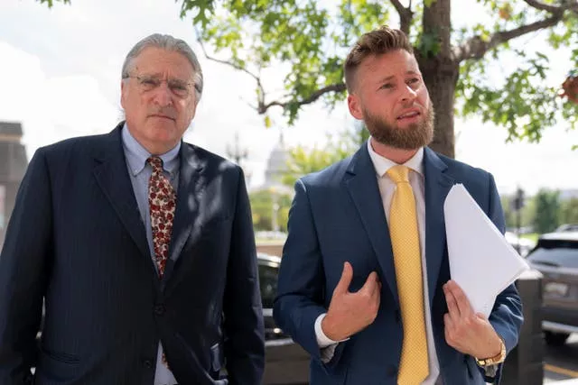 Infowars host Owen Shroyer, accompanied by his lawyer Norm Pattis, speaks to reporters outside the E Barrett Prettyman US Federal Courthouse in Washington