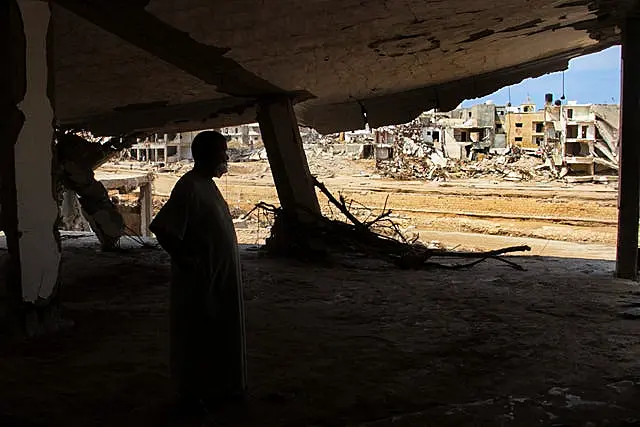 Derna flood survivor Abdul Salam Anwisi looks at destroyed homes