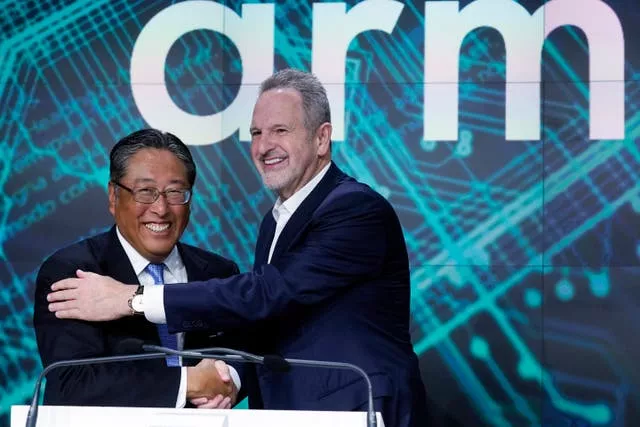 Arm Holdings chief executive Rene Haas, right, and Softbank CFO Yoshimitsu Goto shake hands at the Nasdaq MarketSite during the ARM Holdings IPO in New York’s Times Square 