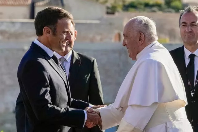 Pope Francis is welcomed by French President Emmanuel Macron as he arrives at the final session of the Rencontres Mediterraneennes meeting at the Palais du Pharo in Marseille, France