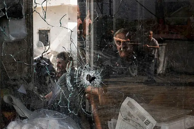 A bullet hole is seen in a shop window following an Israeli military raid in the Jenin refugee camp