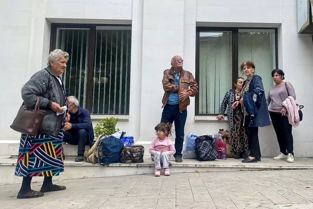 Local residents gather near a local government building after reports of shooting in Stepanakert