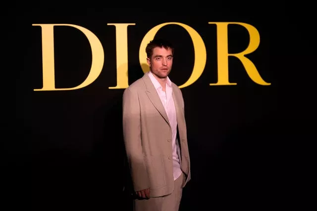 Robert Pattinson poses before Christian Dior Spring/Summer 2024 womenswear collection presented Tuesday, Sept.26, 2023 in Paris